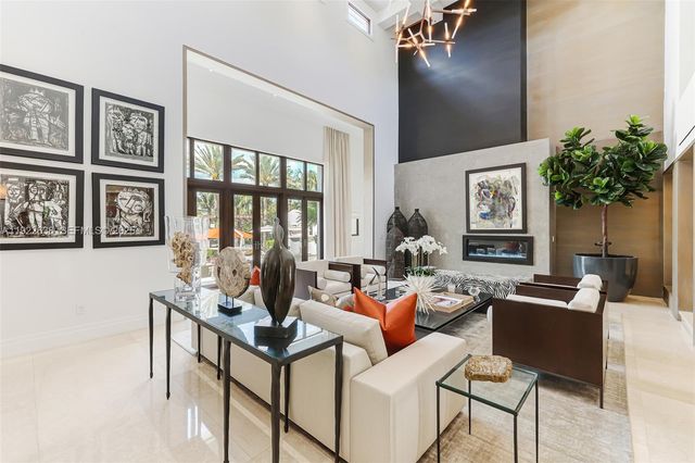 a kitchen with white cabinets and sink