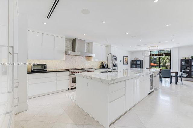 a living room with kitchen island furniture and a view of kitchen