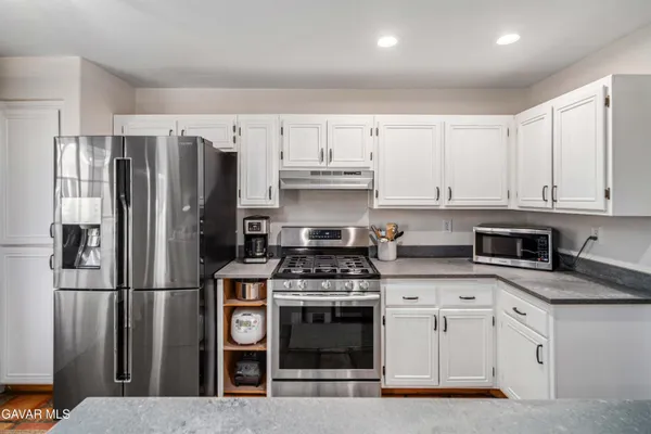 a kitchen with cabinets and stainless steel appliances