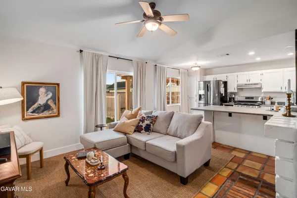 a living room with furniture and kitchen view
