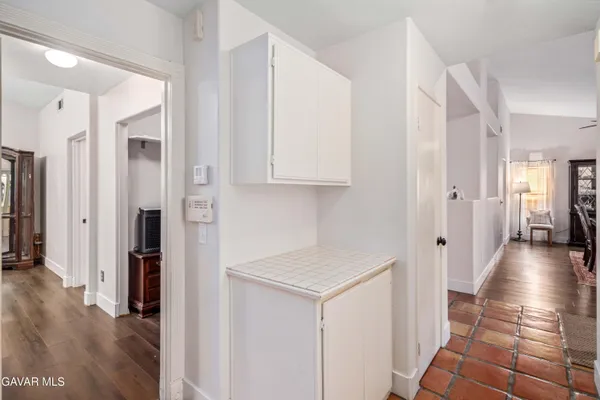 a view of a hallway with wooden floor and closet