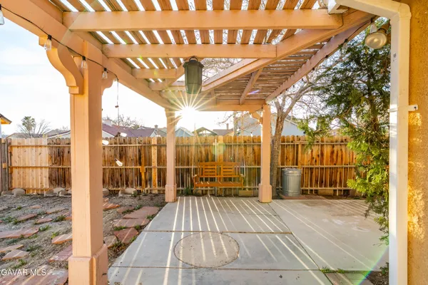 a view of a backyard with wooden fence