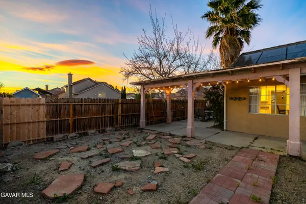 a backyard of a house with table and chairs