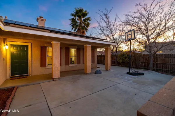 a view of a house with backyard porch and sitting area