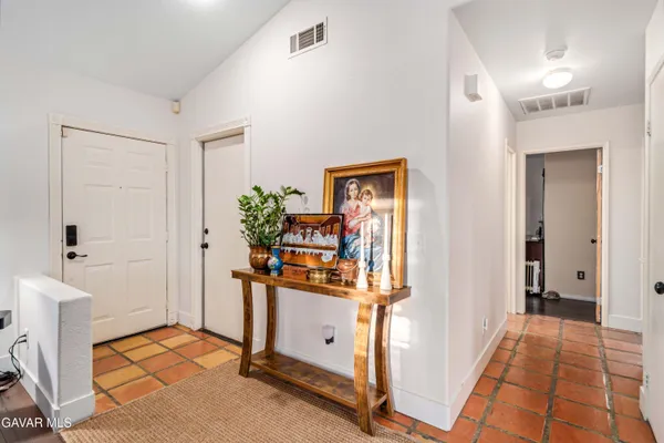 a view of a hallway with workspace and living room