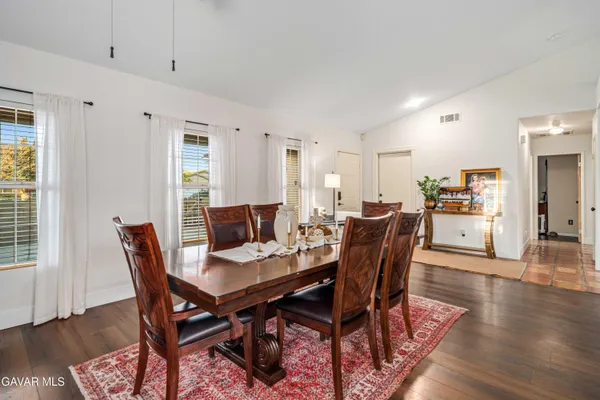 a view of a dining room with furniture and wooden floor