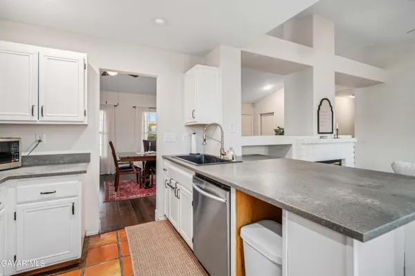 a kitchen with white cabinets and appliances
