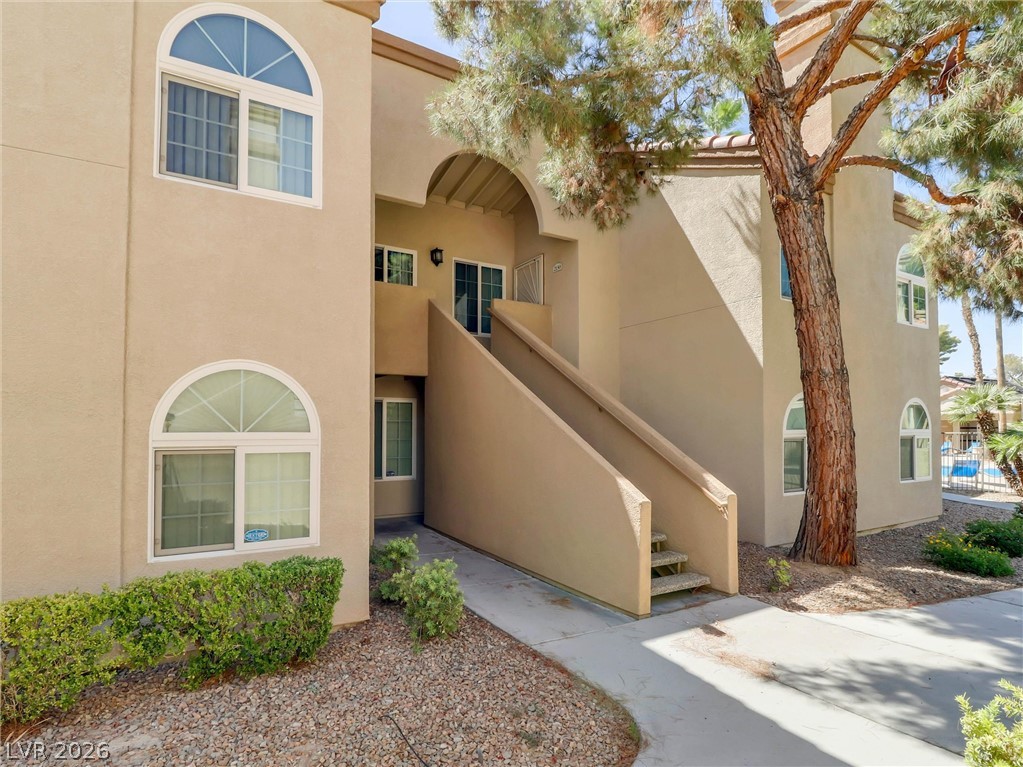 3145 East Flamingo Road, Unit 2129 Las Vegas, NV 89121 - Photo 2 of 43 A graceful exterior with arched windows complements the warm stucco finish and thoughtful landscaping.