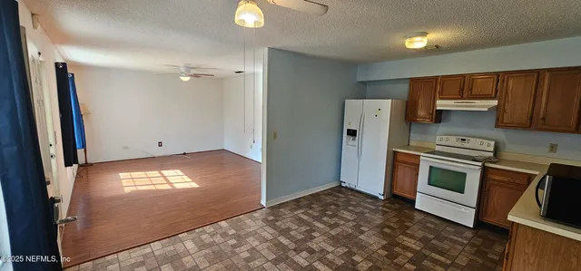a kitchen with a refrigerator stove and a sink