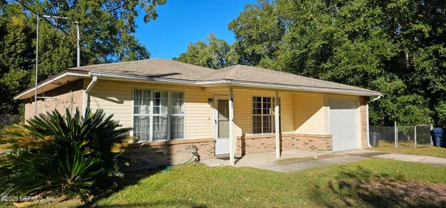 a patio with a table and chairs and potted plants