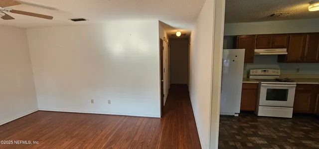 a view of a kitchen from the hallway