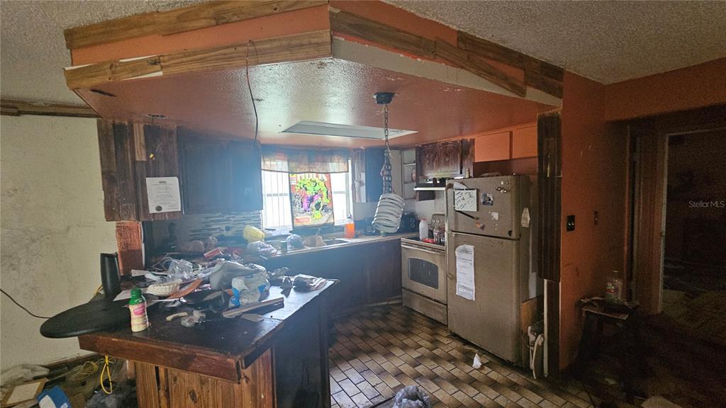 8428 Paxton Drive Port Richey, FL 34668 - Photo 17 of 100 a kitchen with refrigerator and cabinets
