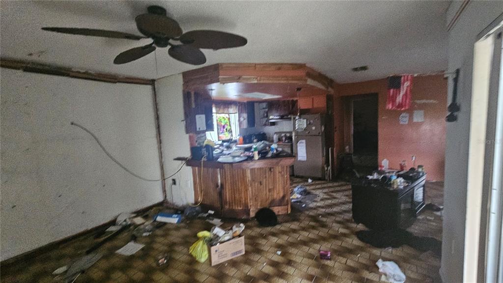 8428 Paxton Drive Port Richey, FL 34668 - Photo 19 of 100 a room with lots of wooden furniture and a chandelier