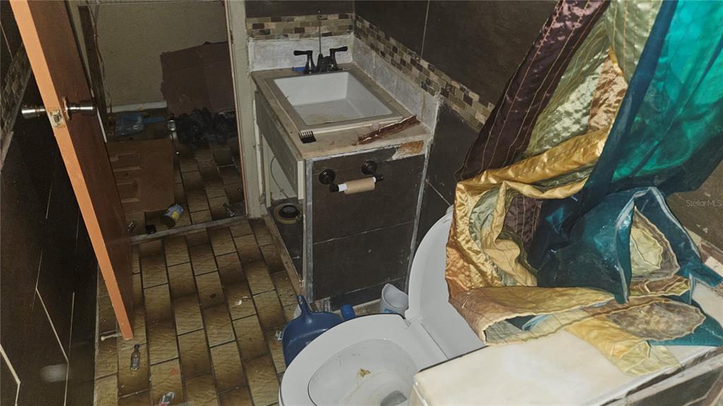 8428 Paxton Drive Port Richey, FL 34668 - Photo 51 of 100 a bathroom with a sink toilet and mirror