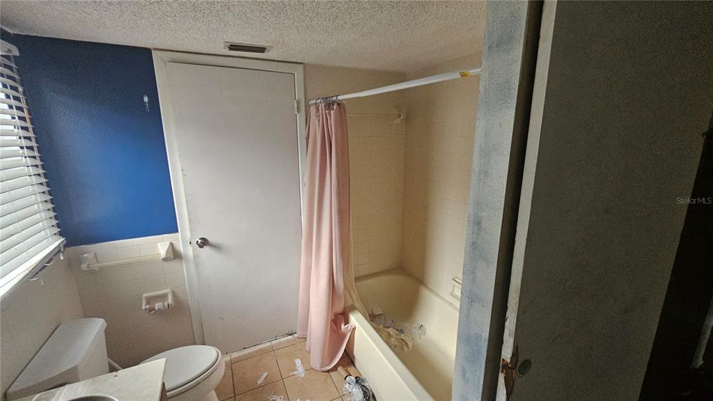 8428 Paxton Drive Port Richey, FL 34668 - Photo 66 of 100 a bathroom with a shower and a toilet