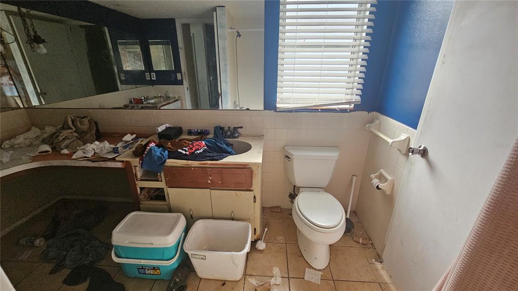 8428 Paxton Drive Port Richey, FL 34668 - Photo 68 of 100 a bathroom with a toilet a sink and a mirror
