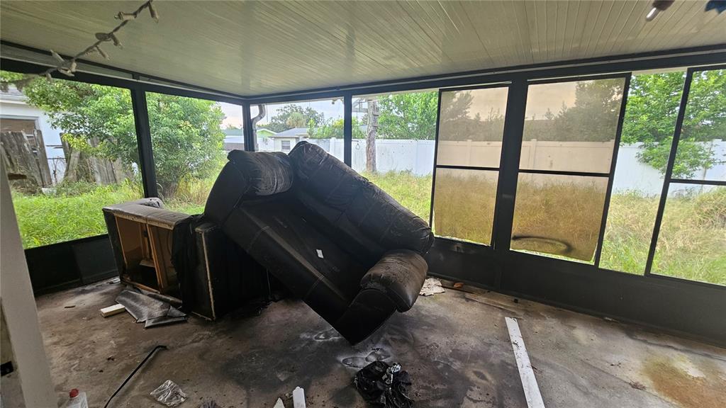 8428 Paxton Drive Port Richey, FL 34668 - Photo 86 of 100 a living room with furniture and a floor to ceiling window