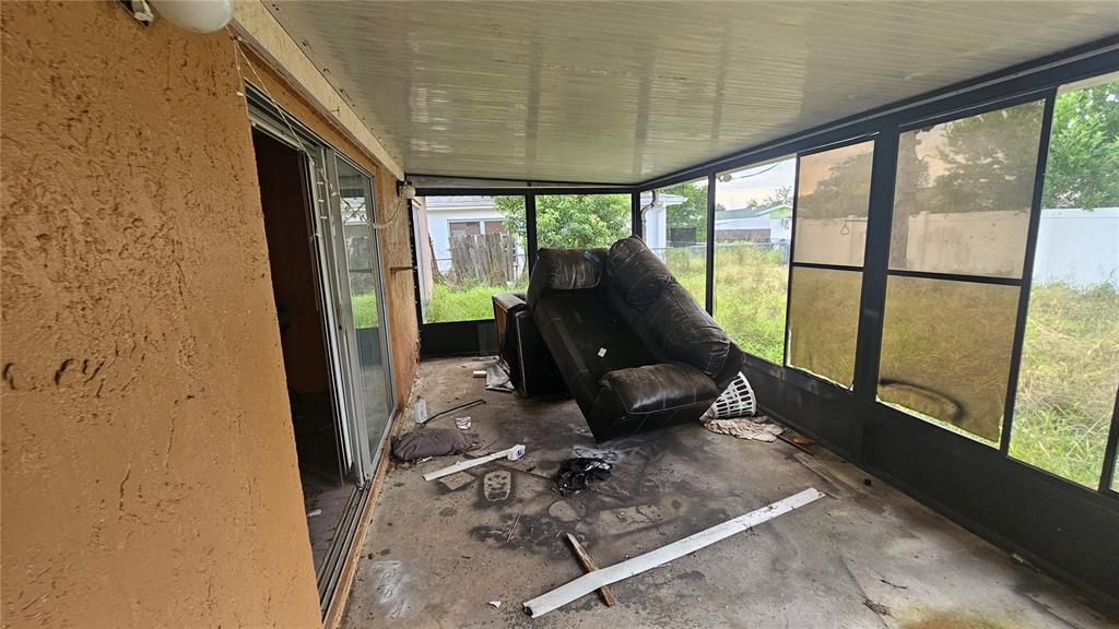 8428 Paxton Drive Port Richey, FL 34668 - Photo 87 of 100 a living room with furniture and a floor to ceiling window