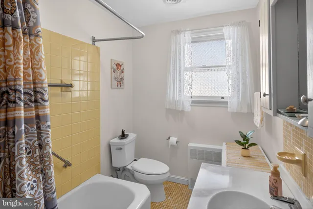 a white toilet sitting next to a bathroom sink