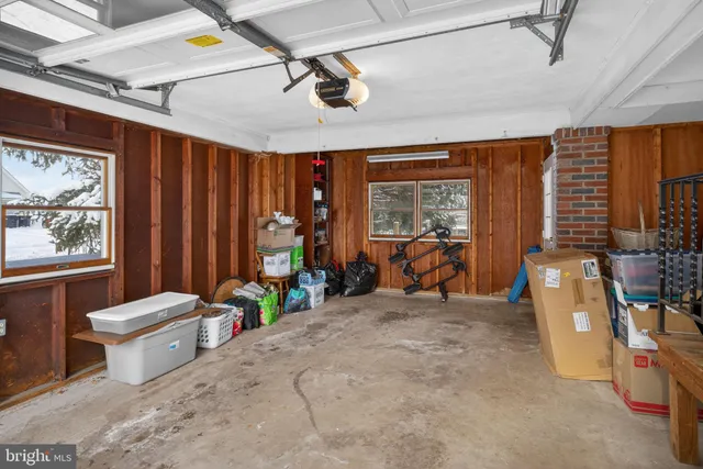 a room with furniture a rug and a window