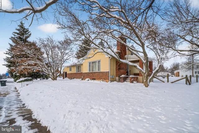 a view of a house with a snow in the yard