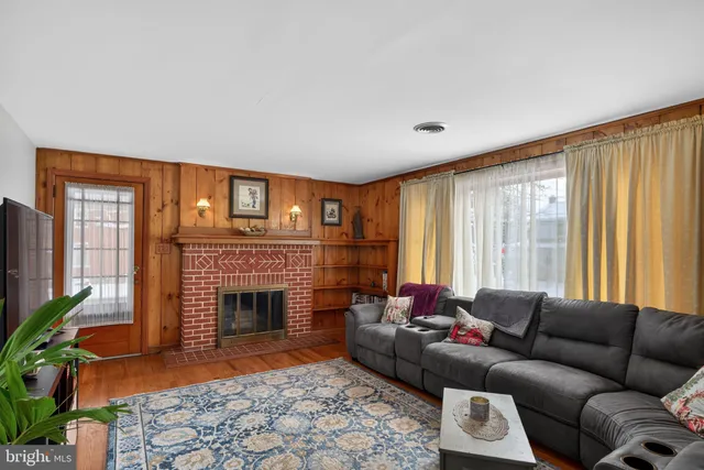 a living room with furniture windows and a fireplace