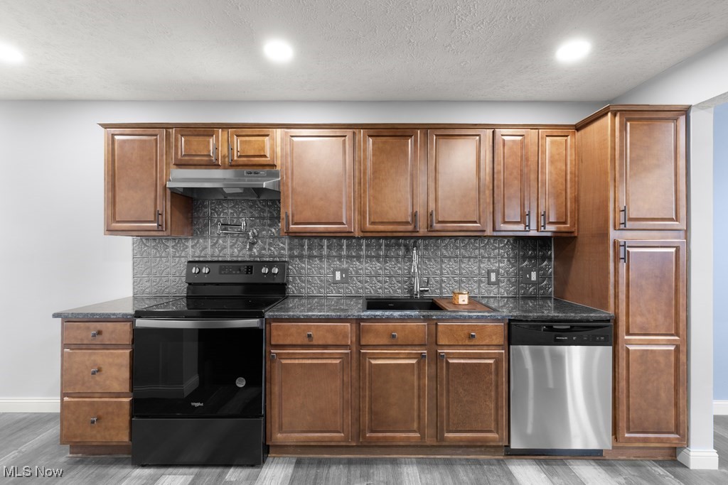139 Patterson Road Weirton, WV 26062 - Photo 12 of 46 Kitchen with range with electric cooktop, stainless steel dishwasher, dark stone counters, decorative backsplash, and recessed lighting