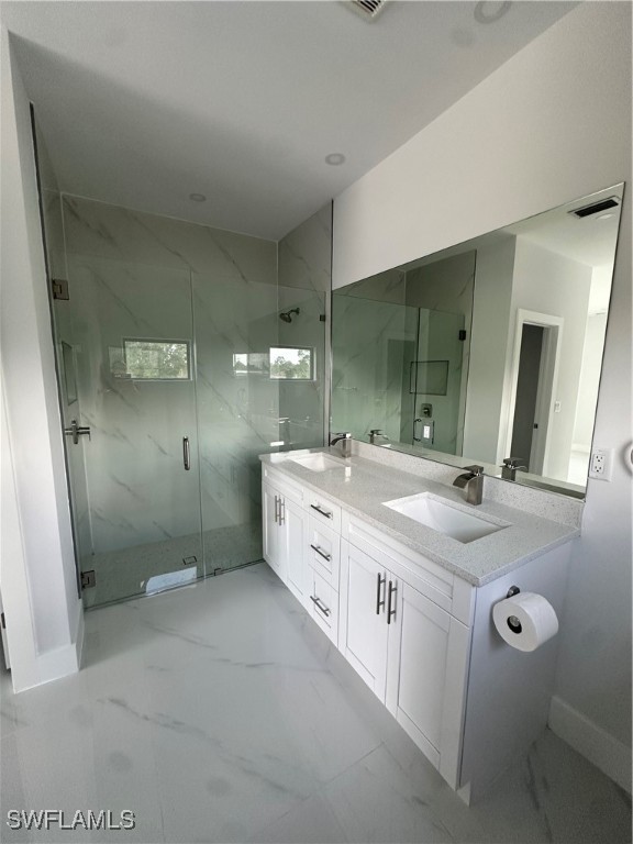 821 Bell Boulevard Lehigh Acres, FL 33974 - Photo 14 of 35 a spacious bathroom with a double vanity sink shower and a mirror