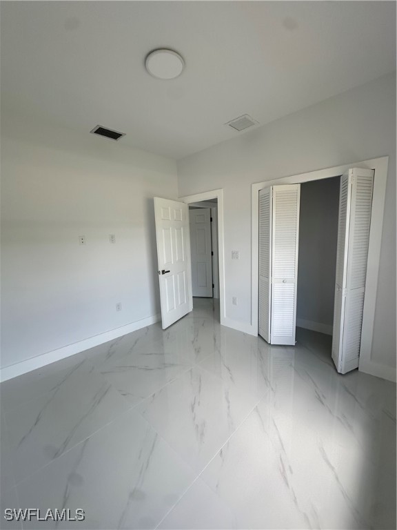 821 Bell Boulevard Lehigh Acres, FL 33974 - Photo 16 of 35 an empty room with a door