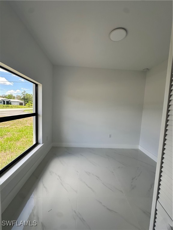 821 Bell Boulevard Lehigh Acres, FL 33974 - Photo 18 of 35 a view of an empty room with a window