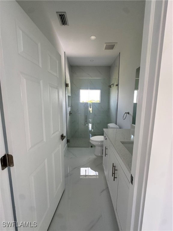 821 Bell Boulevard Lehigh Acres, FL 33974 - Photo 22 of 35 a bathroom with a sink a toilet and shower