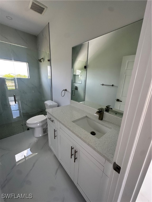 821 Bell Boulevard Lehigh Acres, FL 33974 - Photo 23 of 35 a spacious bathroom with a double vanity sink toilet and a tub