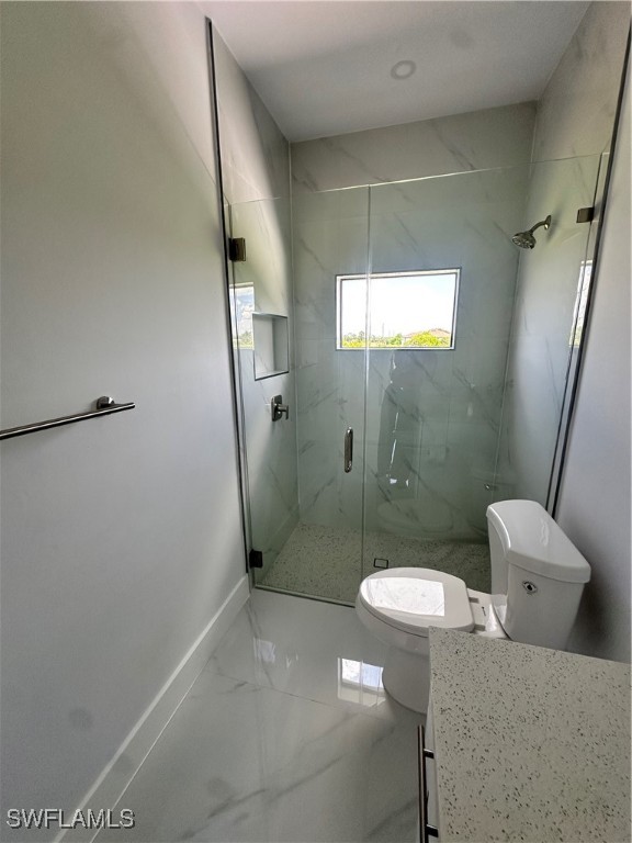 821 Bell Boulevard Lehigh Acres, FL 33974 - Photo 24 of 35 a bathroom with a sink a toilet and shower