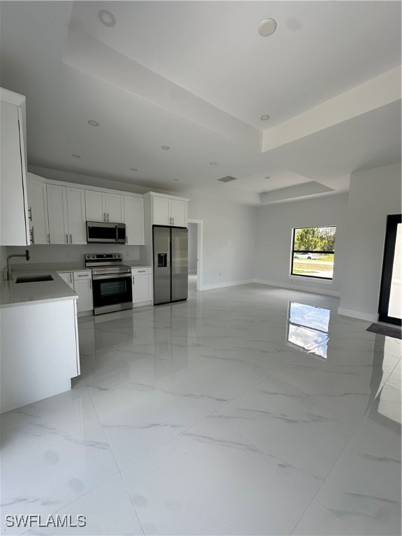 821 Bell Boulevard Lehigh Acres, FL 33974 - Photo 30 of 35 a kitchen with stainless steel appliances a refrigerator a stove a microwave a sink and dishwasher