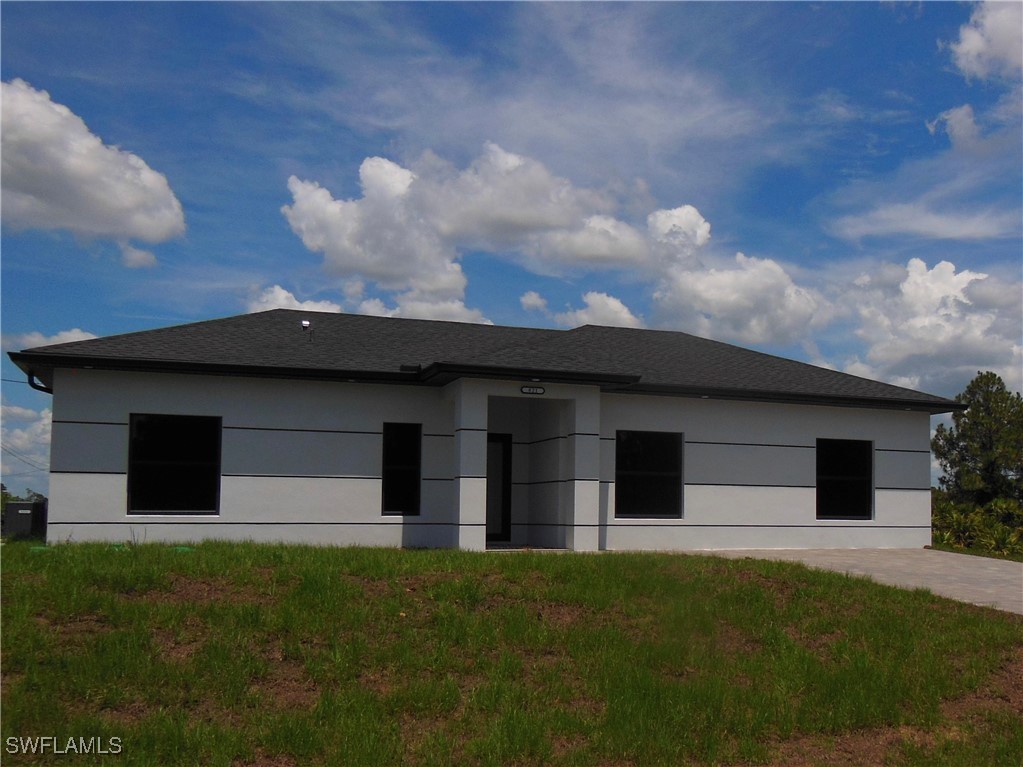 821 Bell Boulevard Lehigh Acres, FL 33974 - Photo 35 of 35 a house with a yard in front of it
