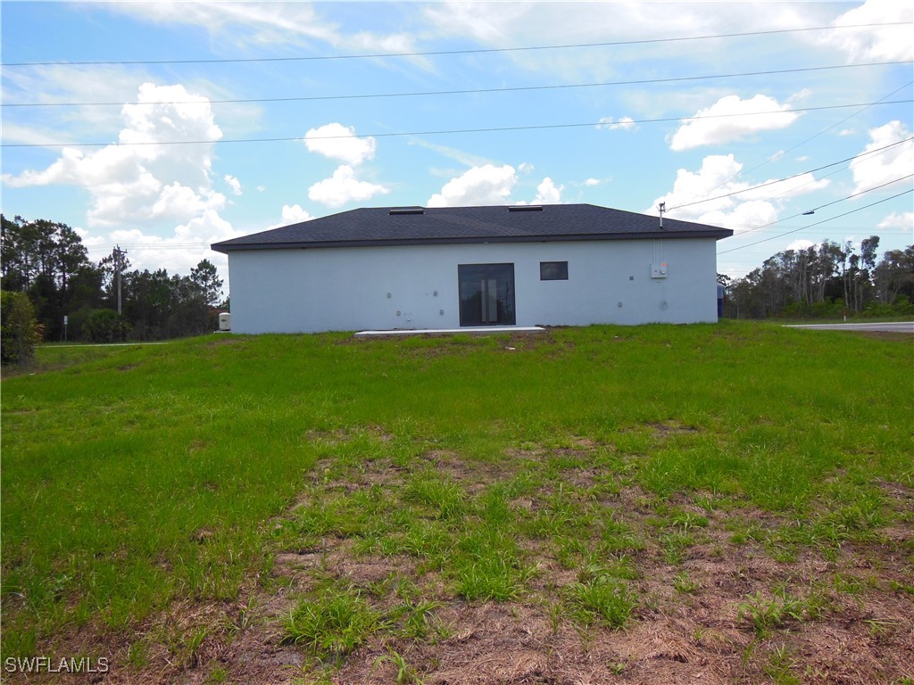 821 Bell Boulevard Lehigh Acres, FL 33974 - Photo 5 of 35 a view of a house with a yard