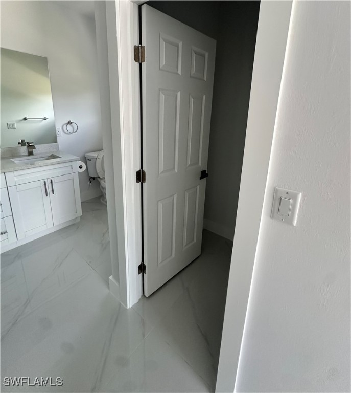 821 Bell Boulevard Lehigh Acres, FL 33974 - Photo 10 of 35 a bathroom with a sink and mirror
