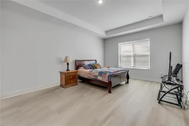 a spacious bedroom with a bed and a window