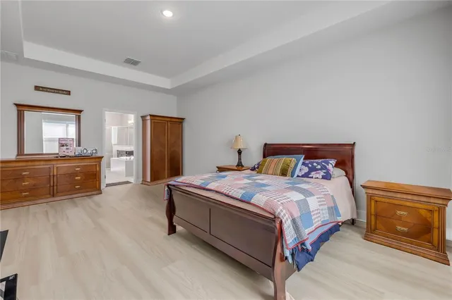 a bedroom with a bed and a view of kitchen