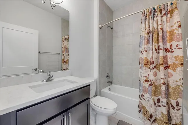 a bathroom with a sink toilet tub and shower