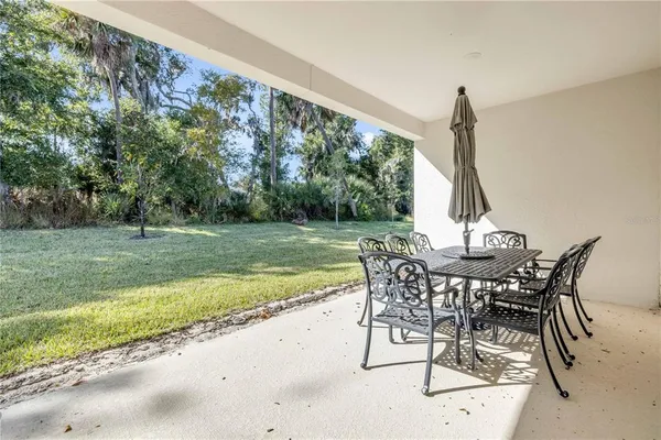 a view of a patio with a table and chairs