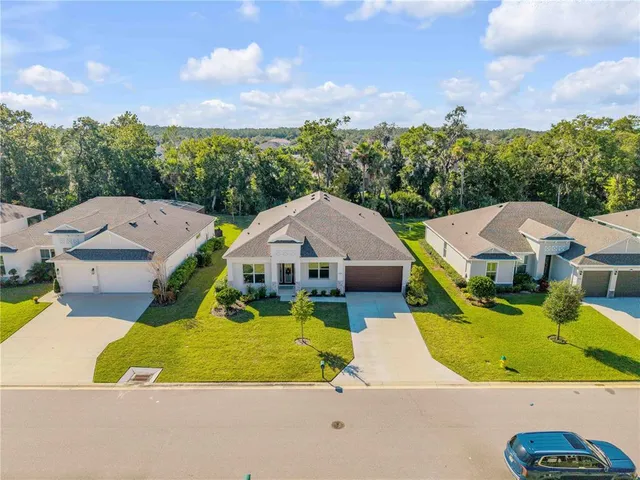 an aerial view of a house with yard swimming pool and outdoor seating