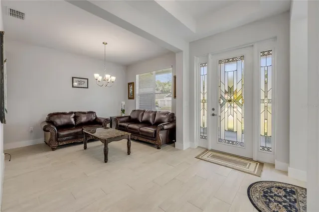 a living room with furniture a lamp and a window