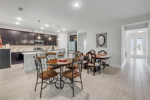 a large kitchen with a table and chairs in it