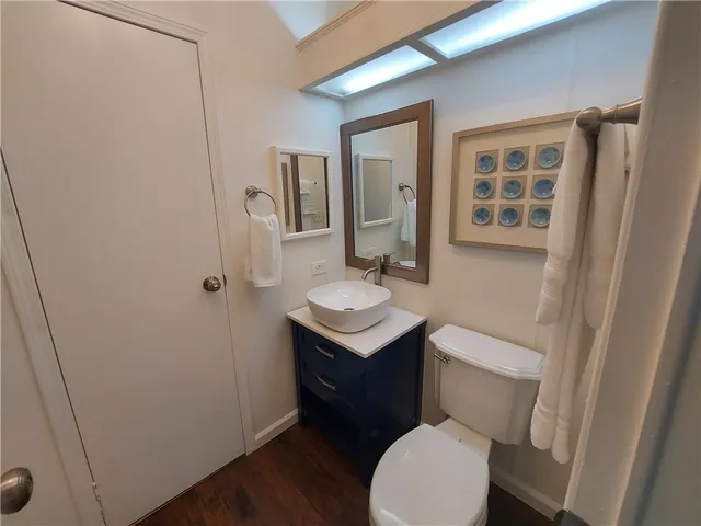 a bathroom with a toilet a sink and mirror