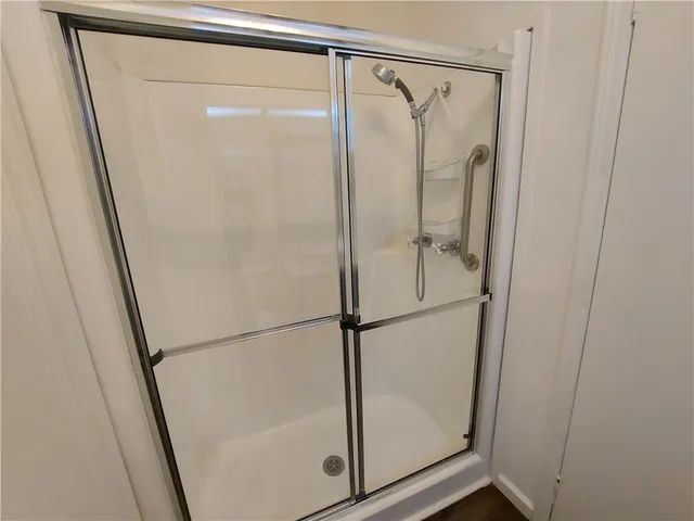 a bathroom with a glass shower door