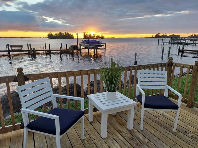a balcony with wooden floor outdoor seating and city view