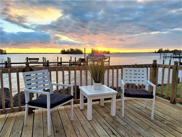 a view of a balcony with wooden floor outdoor seating