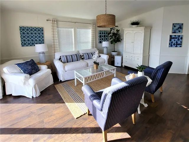 a living room with furniture a rug and a chandelier