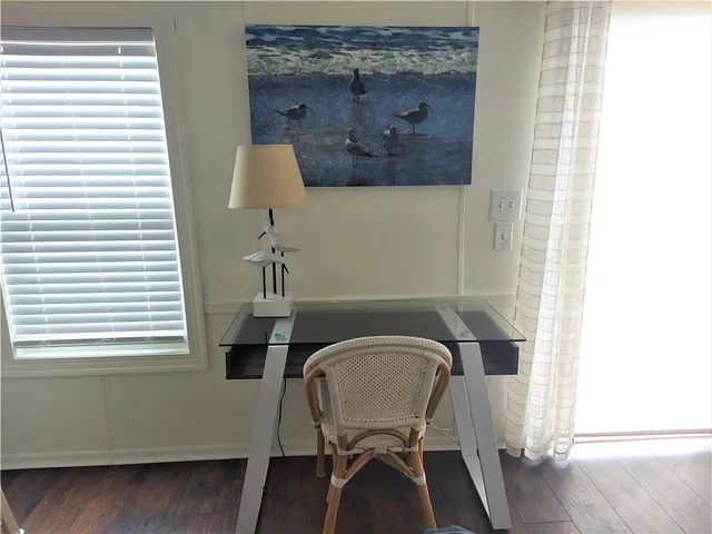 a view of a room with a table and chairs